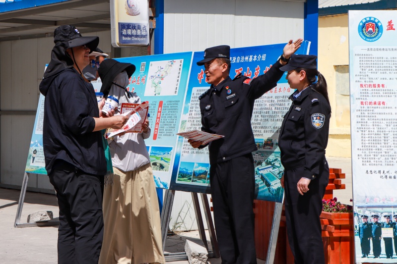 图为民警正在为群众讲解民法典,共创平安边境旅游,“典”亮美好生活 (3)(1).jpg