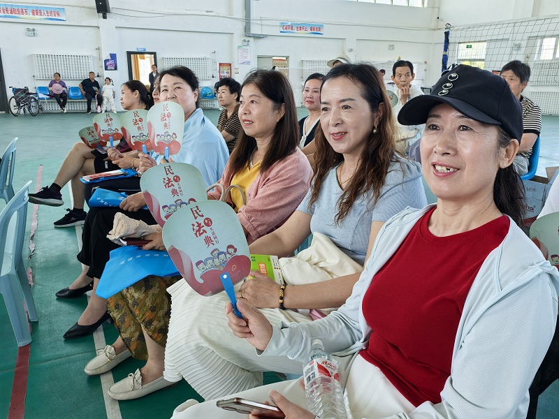居民手持民法典扇子认真观看节目（薛世凡）.jpg