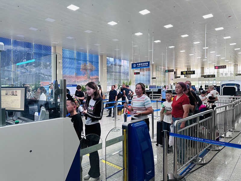 图为出境旅客正在巴克图口岸办理边检手续.jpg